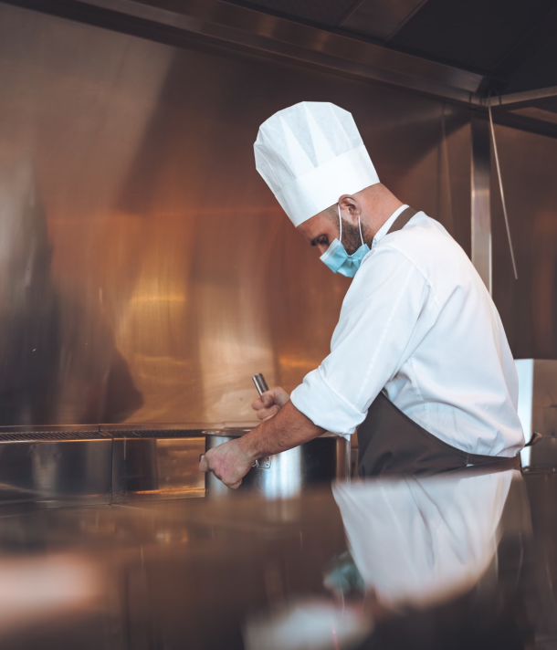 Chef stirring pot in the kitchen