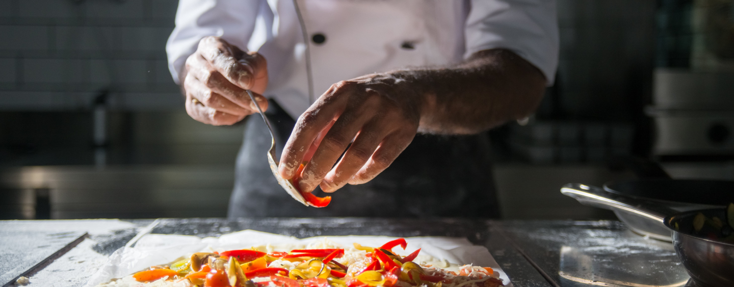 Chef placing Bell Peppers onto food